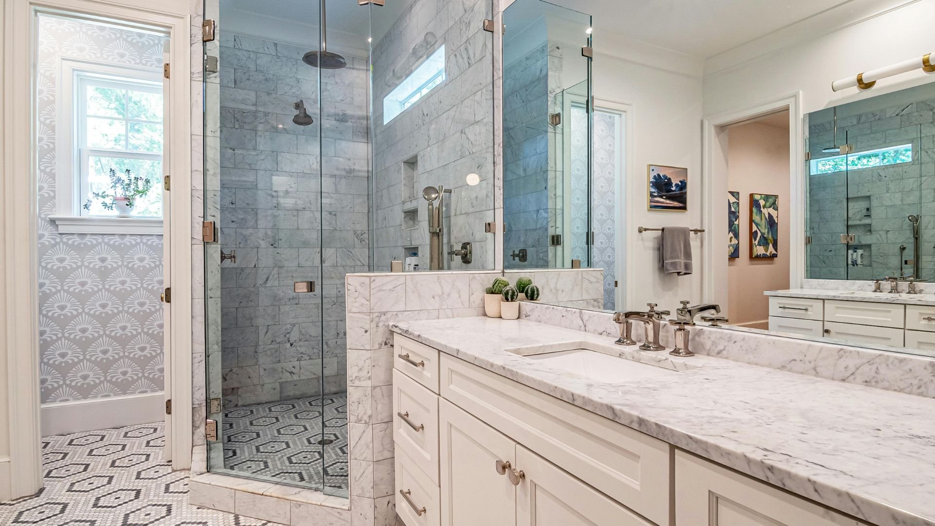 Luxurious marble bathroom with glass shower and white vanity