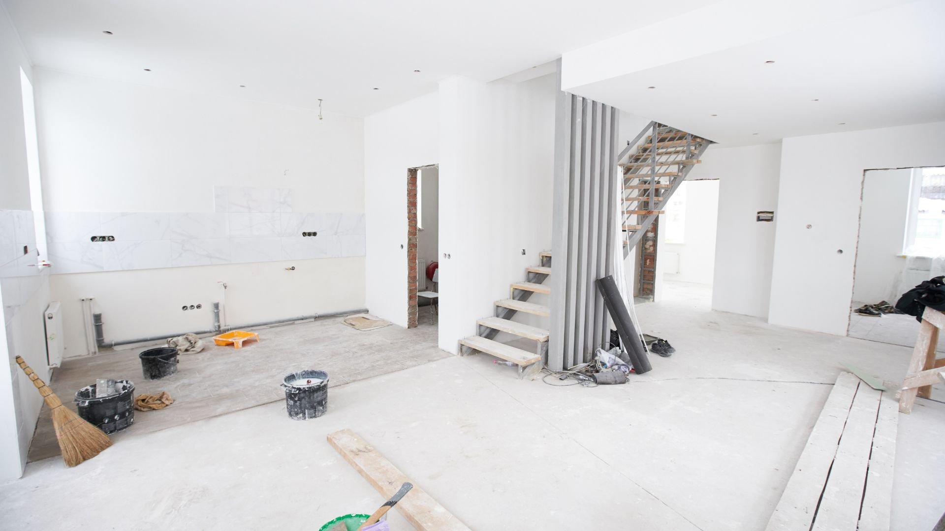 Interior of a house under renovation with white walls and construction materials
